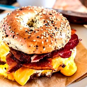 1 sandwich (212 g) Asiago Cheese Bagel Breakfast Sandwich with Bacon