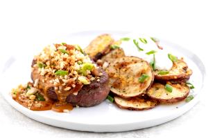 1 serving Bacon and Green Onion-Crusted Steak with Loaded Cheddar-Jack Potatoes