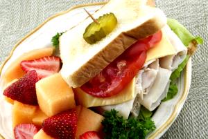 1 Serving Turkey Sandwich With Side Of Fruit At Desert Grill