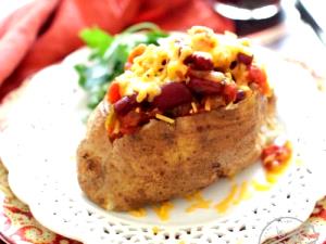 100 G Baked Potato Topped with Cheese Sauce and Chili